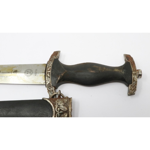 2186 - An aged replica SS presentation dagger with leather bound and metal mounted scabbard, etched blade a... 