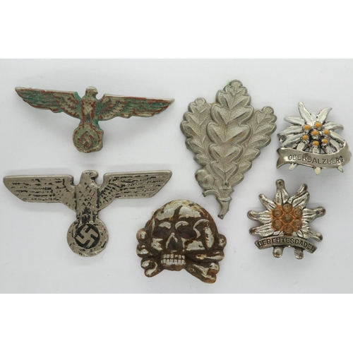 2264 - A collection of German WWII and later cap and uniform badges, including Totenkopf skull, cap eagle e... 