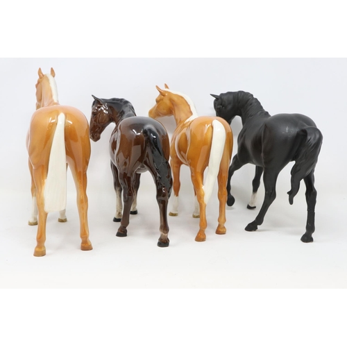 204 - Four Beswick horses, including two Palomino examples, no cracks or chips, largest H: 21 cm. UK P&P G... 