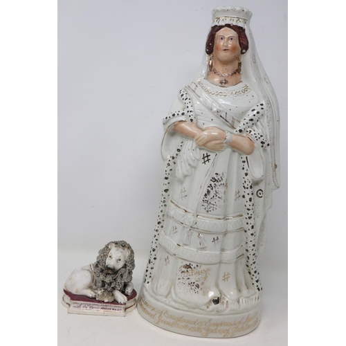 272 - Late 19th Century Staffordshire Queen Victoria figurine and a lion, figure has crazing throughout, c... 