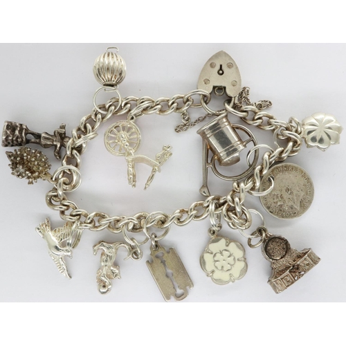 4 - Hallmarked silver charm bracelet with twelve charms, padlock clasp and safety chain, L: 18 cm, 40g. ... 