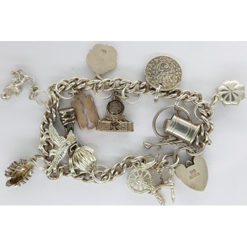 4 - Hallmarked silver charm bracelet with twelve charms, padlock clasp and safety chain, L: 18 cm, 40g. ... 