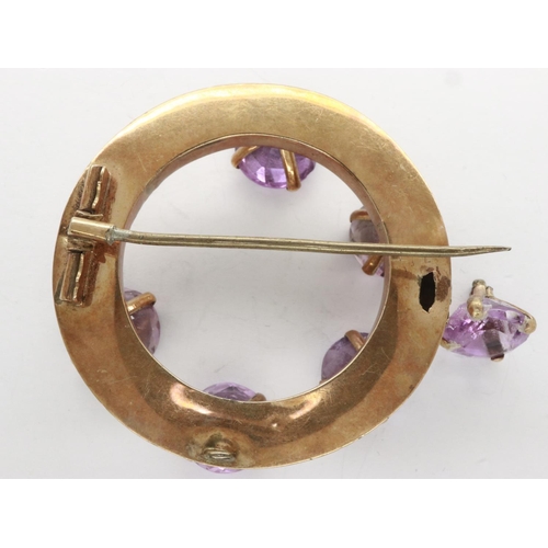 7 - Unmarked gold brooch set with with six large amethysts, one amethyst loose but present, also lacking... 