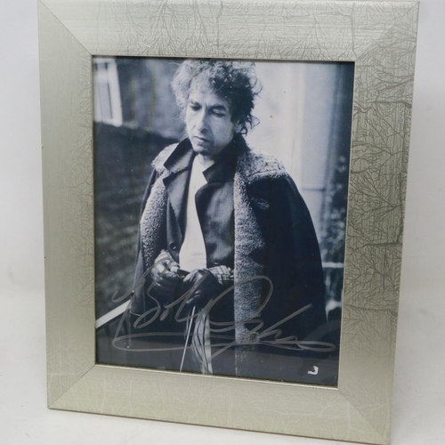 128 - Framed photograph signed by Bob Dylan, certificate of authenticity in back of frame. Not available f... 