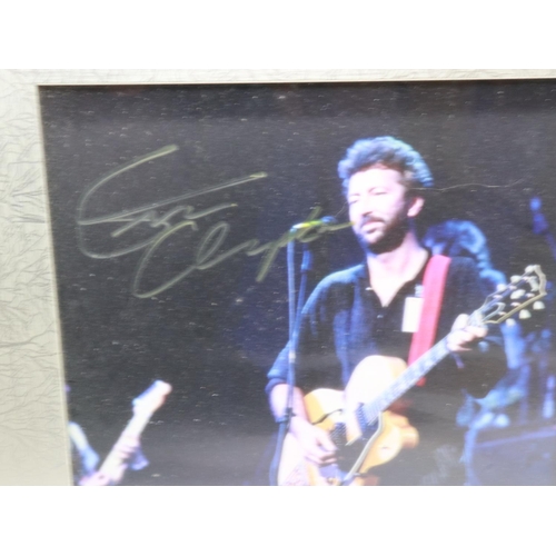 129 - Framed photograph signed by Eric Clapton, certificate of authenticity in back of frame. Not availabl... 