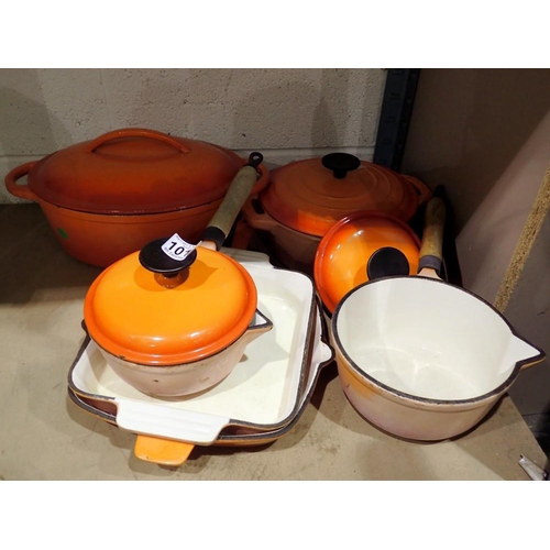 1016 - Three pans, stew pot and a casserole dish by Le Creuset, all in orange. Not available for in-house P... 