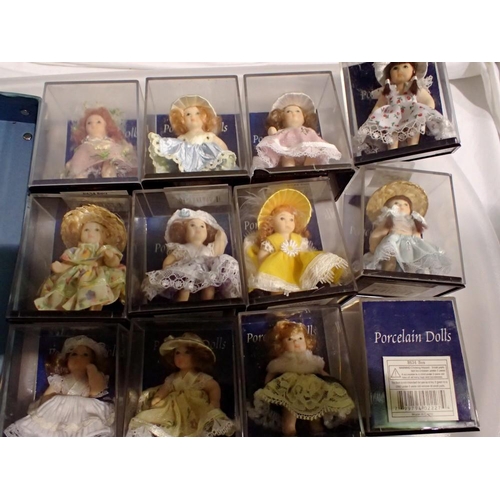 1085 - Twelve mixed small boxed porcelain dolls. Not available for in-house P&P