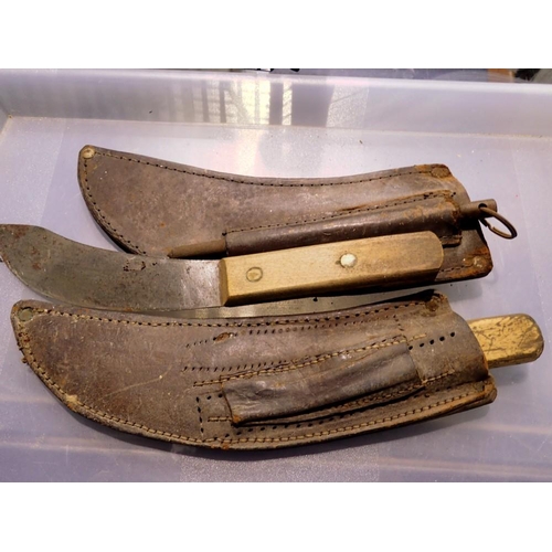 1077 - Two vintage leather sheathed knives. Not available for in-house P&P