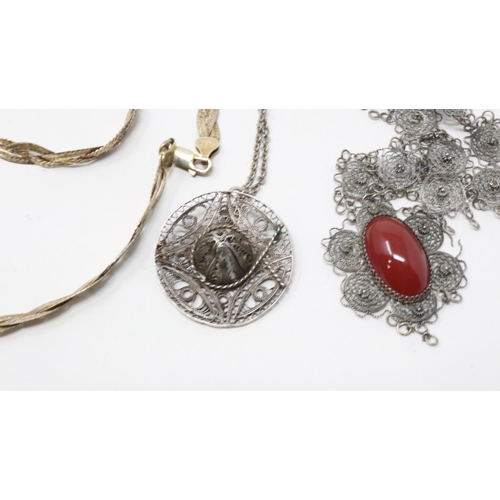 71 - Four mixed silver necklaces and pendant necklaces including a gilt silver example, largest chain L: ... 