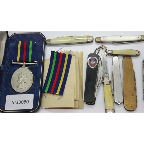 157 - QEII Civil Defence Long Service medal, boxed, not named together with seven folding vintage knives. ... 