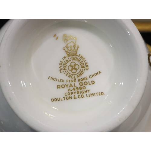 270 - Royal Doulton tea and dinnerware in the Royal Gold pattern of twenty six pieces, H4980, no cracks or... 