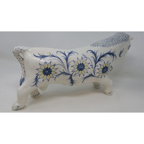 297 - Arnold Machin for Wedgwood Queensware, a mid 20th century painted bull, hairline crack from head to ... 