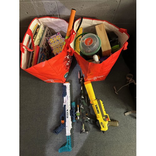 1043A - Two bags of childs mixed items to include Nerf gun toy, mixed books, other toy items etc. Not availa... 