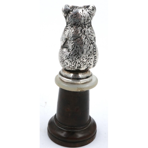 137 - Edwardian hallmarked silver teddy bear figurine, set with turquoise eyes and mounted on a turned woo... 