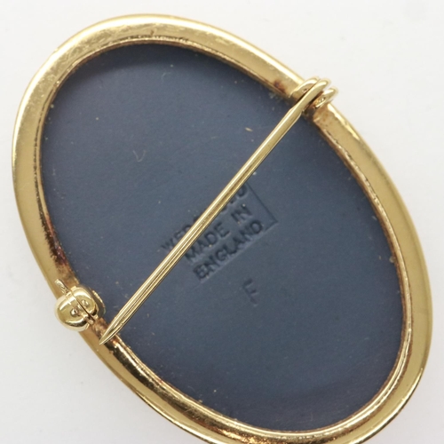 14 - Wedgwood blue Jasperware and gilt brooch, H: 42 mm. UK P&P Group 0 (£6+VAT for the first lot and £1+... 