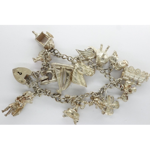 41 - Silver charm bracelet with padlock clasp and fourteen charms, L: 18 cm. UK P&P Group 0 (£6+VAT for t... 