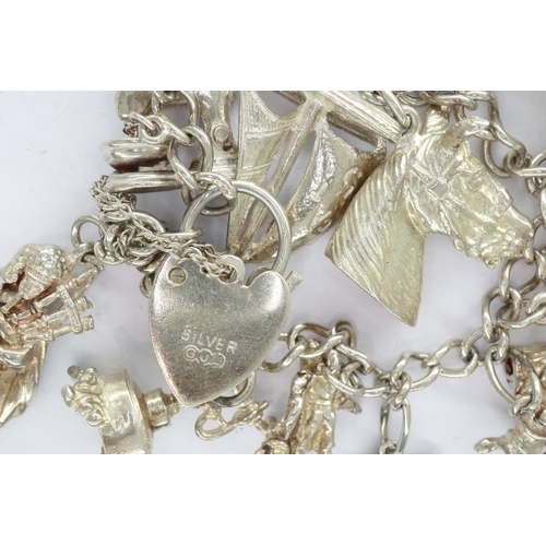 41 - Silver charm bracelet with padlock clasp and fourteen charms, L: 18 cm. UK P&P Group 0 (£6+VAT for t... 