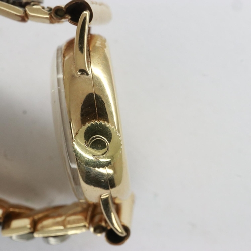 100 - OMEGA: 9ct gold cased ladies wristwatch on an expanding bracelet, 14.2g, working at lotting, damage ... 