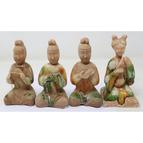 165 - Four Ming Dynasty glazed tomb guardians, each holding musical instruments, losses and repaired damag... 