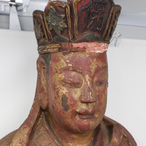 202 - A large and rare Ming Dynasty gilt wood seated figure of a court official, raised on a lotus-leaf ba... 