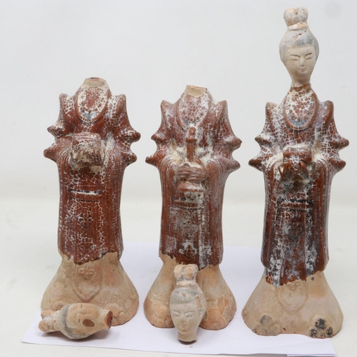 176 - Three Ming Dynasty tomb guardians, each holding a receptacle, damages to each neck, largest H: 27 cm... 