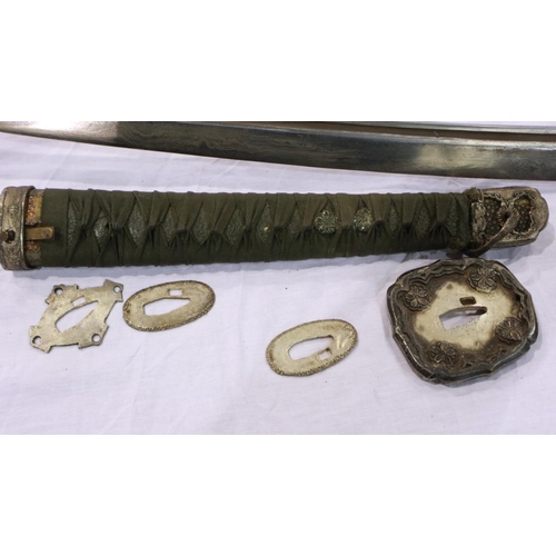 2150 - A Japanese WWII officers katana, the blade of Damascus steel having a signed handle beneath the shag... 