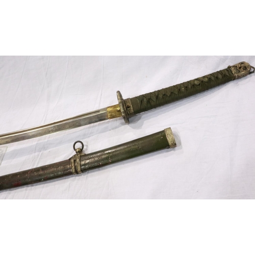 2150 - A Japanese WWII officers katana, the blade of Damascus steel having a signed handle beneath the shag... 