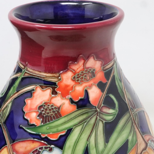 208 - Red ground Moorcroft vase in the Plevriana pattern, no cracks or chips, H: 20 cm, boxed. UK P&P Grou... 