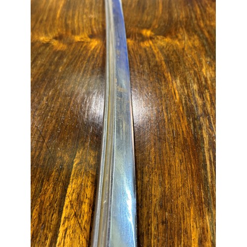 2150 - A Japanese WWII officers katana, the blade of Damascus steel having a signed handle beneath the shag... 