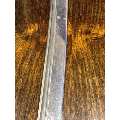 2150 - A Japanese WWII officers katana, the blade of Damascus steel having a signed handle beneath the shag... 