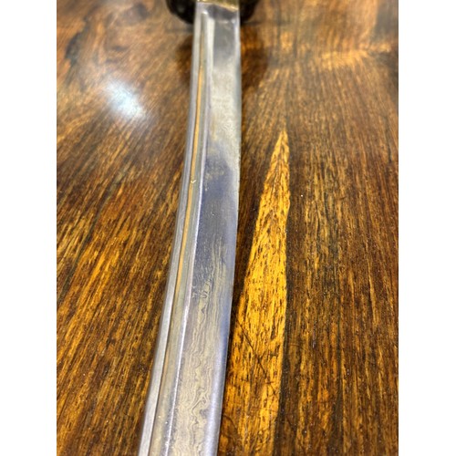 2150 - A Japanese WWII officers katana, the blade of Damascus steel having a signed handle beneath the shag... 