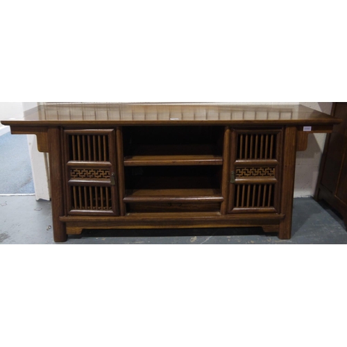 2061 - A 20th century hardwood media stand in the Oriental manner, having two shelves flanked by pierced cu... 