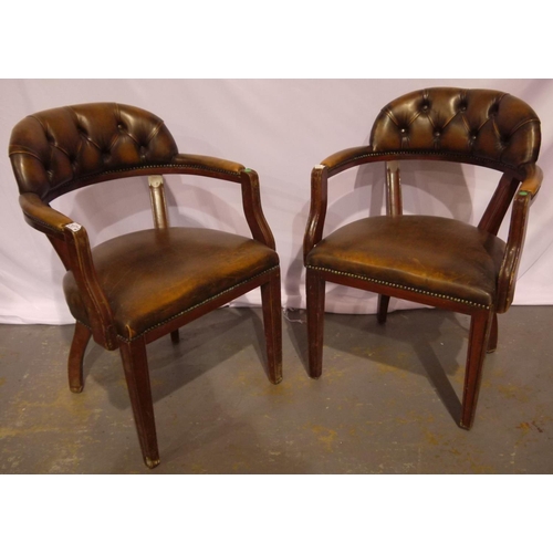 2072 - A pair of 20th century brown leather Chesterfield desk chairs.