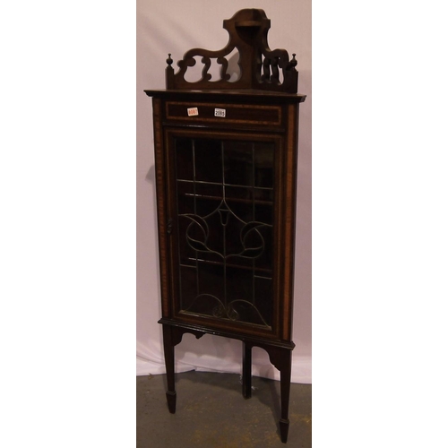 2085 - An Edwardian inlaid mahogany floor standing corner cabinet, the single door set with leaded stained ... 