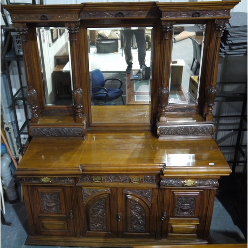 2092 - A substantial Victorian walnut sideboard with monumental upstand and mirrored back, carved facia's a... 