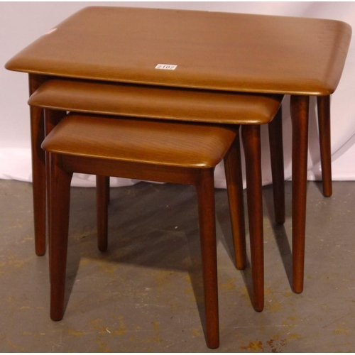 2107 - An Ercol nest of three graduating elm tables. Largest with repaired leg.