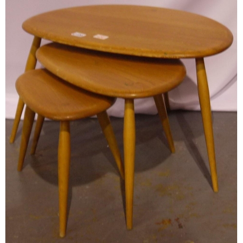 2109 - Ercol nest of three elm Pebble tables, largest 65 x 45 x 40 cm H. Smallest with repaired leg.