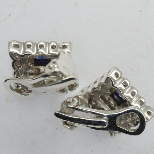 96 - Pair of 18ct white gold clip-on earrings, set with princess cut sapphires and diamonds, combined 7.3... 