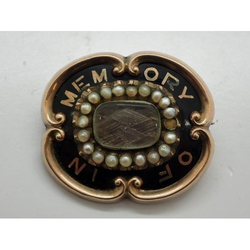 66 - 19th century yellow metal mourning brooch, enamelled in black and set with a panel of braided hair, ... 