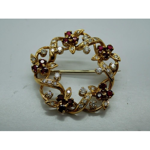 98 - Unmarked yellow gold diamond and ruby set wreath form brooch, D: 30 mm, 7.1g, boxed. UK P&P Group 0 ... 