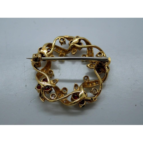 98 - Unmarked yellow gold diamond and ruby set wreath form brooch, D: 30 mm, 7.1g, boxed. UK P&P Group 0 ... 