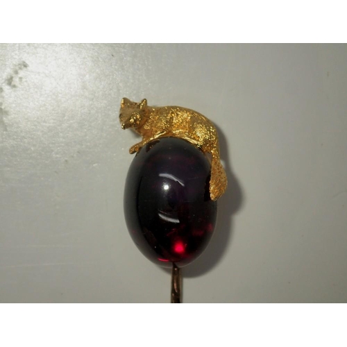 131 - Yellow gold (unmarked) tiepin, the head in the form of a fox over a large cabochon of amethyst, over... 