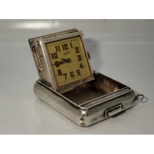 145 - TISSOT: 935 silver cased folding travel clock, manual wind with square dial, working at lotting, som... 