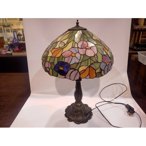 368 - Tiffany style table lamp on a brass base, shade decorated with flowers, H: 63 cm. All electrical ite... 