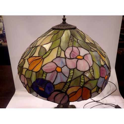 368 - Tiffany style table lamp on a brass base, shade decorated with flowers, H: 63 cm. All electrical ite... 