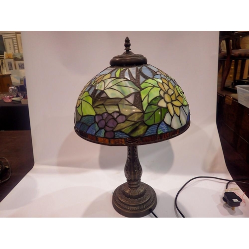 370 - Tiffany style table lamp on a brass base, shade decorated with flowers, H: 58 cm. All electrical ite... 