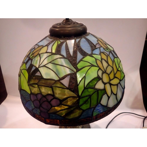 370 - Tiffany style table lamp on a brass base, shade decorated with flowers, H: 58 cm. All electrical ite... 