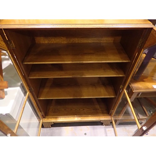 1526 - Oak two door glazed bookcase. Steady on its feet, minor scuffs, very good condition overall. Not ava... 