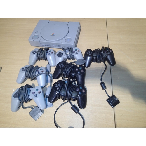 2223 - 4530 Sony Playstation V1, power light comes on, disc mount missing, five control pads and two afterm... 