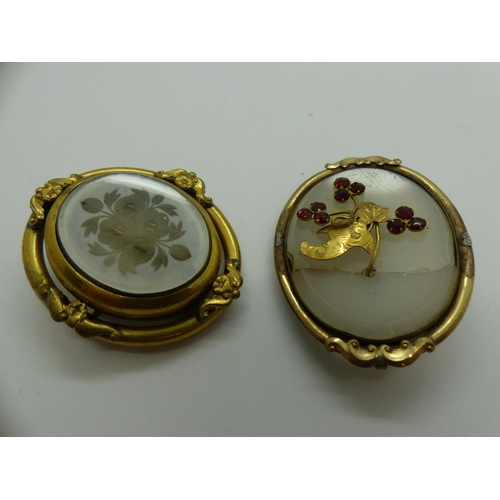 62 - Two yellow metal mounted brooches, one a mourning brooch the other stone set with a cracked stone. U... 